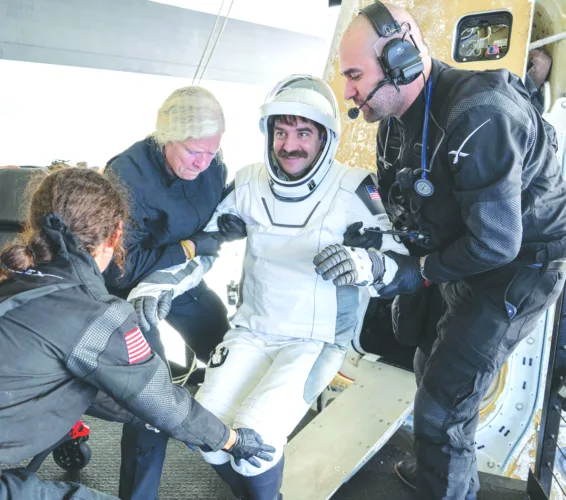 Astronauts return from 8-month stay on space station